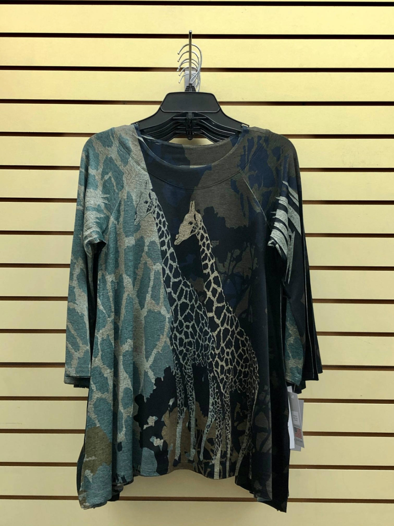 Olive and teal giraffe safari print three-quarter sleeve tunic on hanger