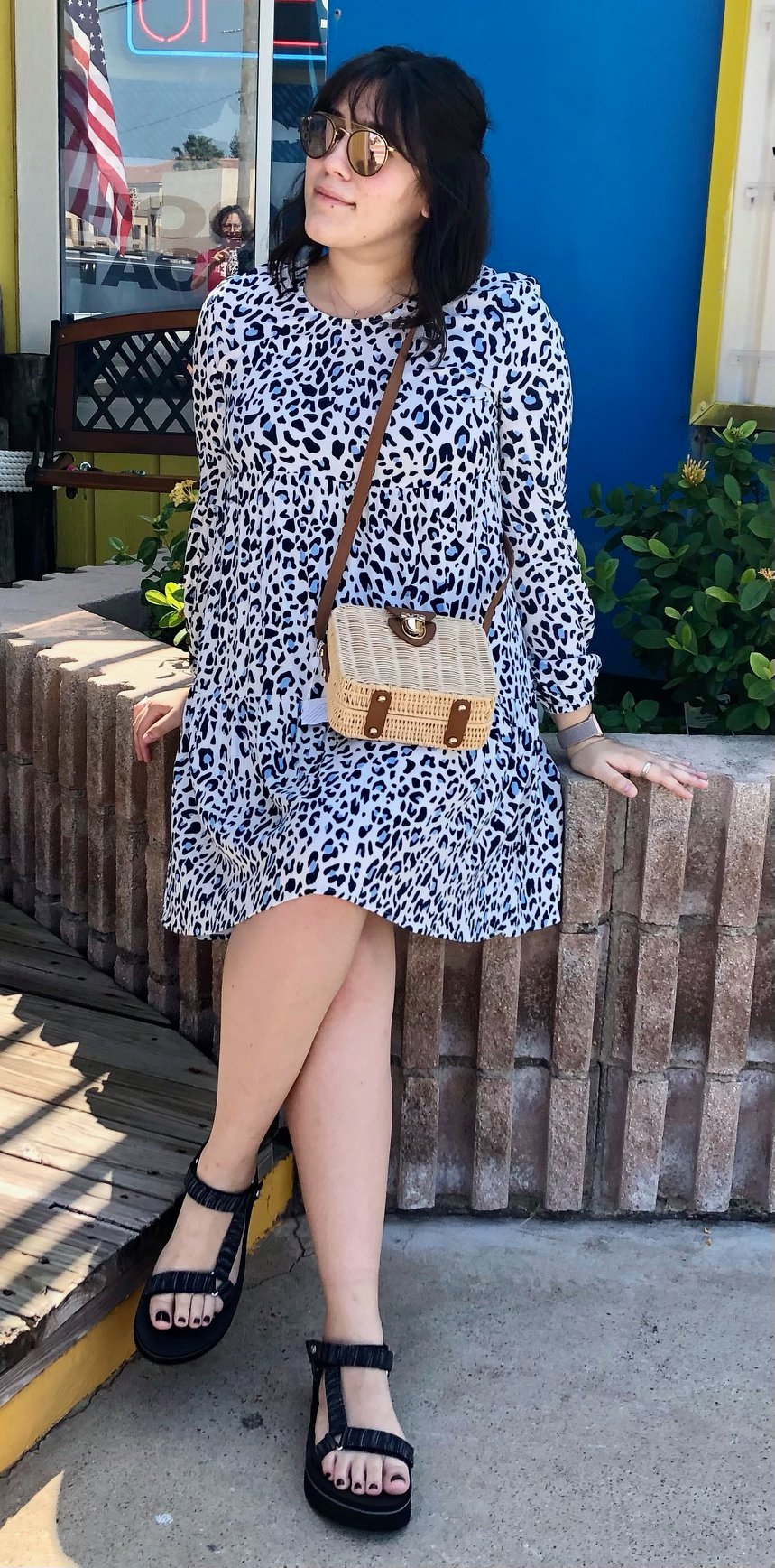 Customer in tiered leopard print dress with rattan crossbody and black platform sandals