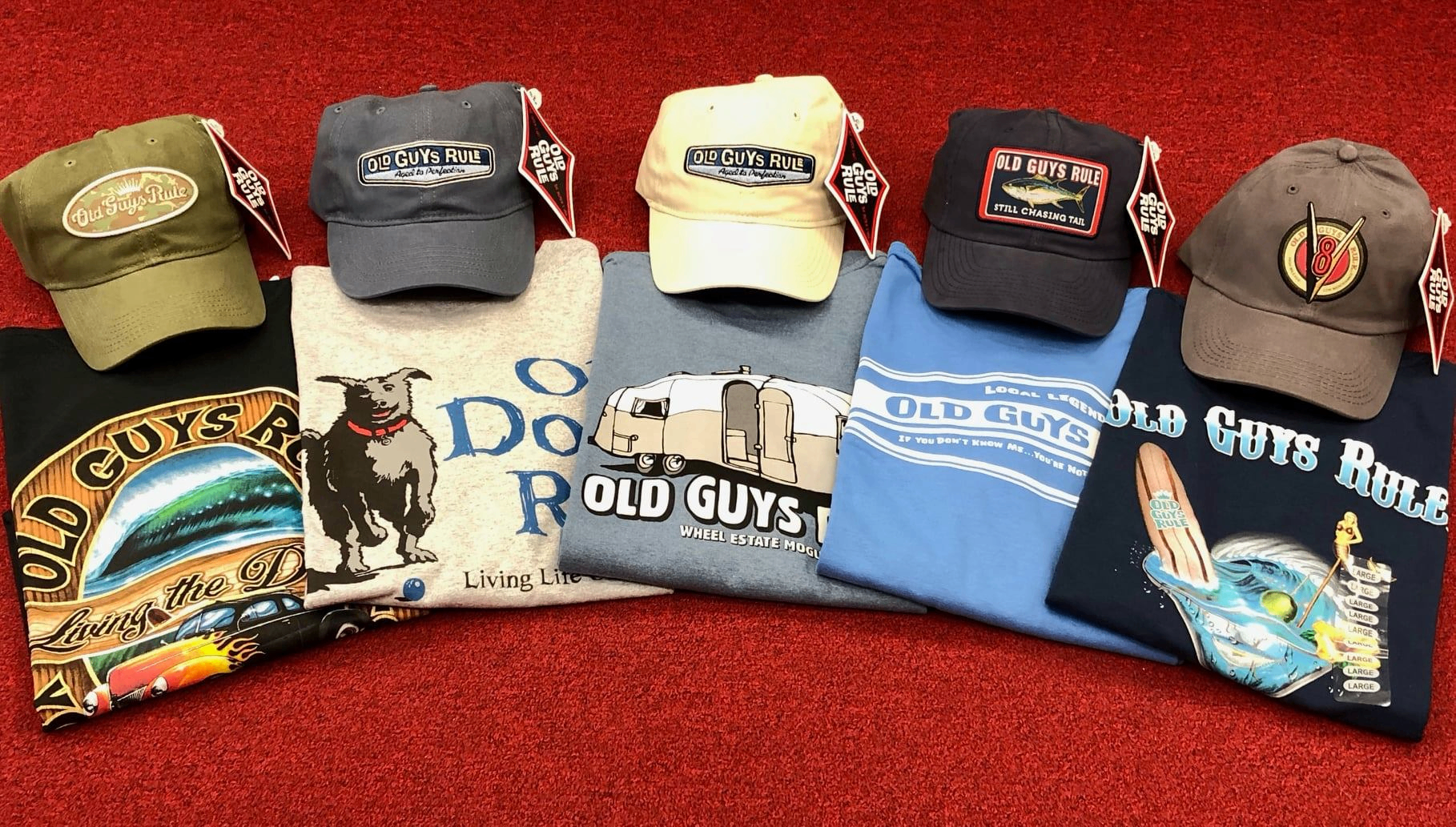 Old Guys Rule hats and graphic tees displayed together